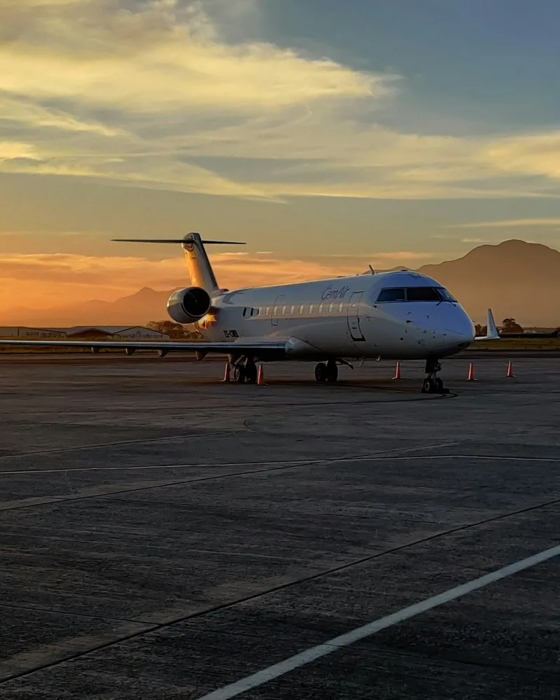Business jet parked on the apron at sunset